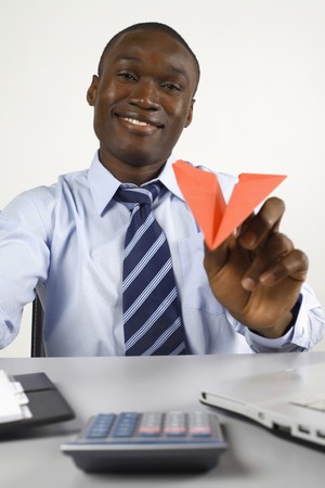 Businessman playing with paper airplaneの写真素材