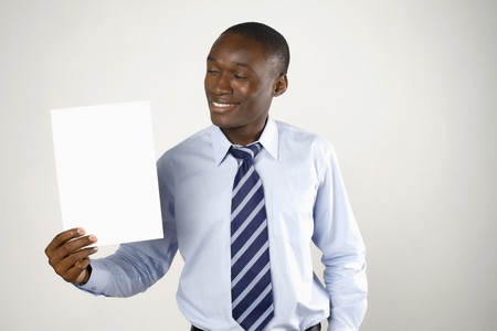 Businessman holding up a piece of blank paperの写真素材