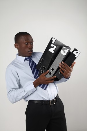 Businessman carrying a stack of foldersの写真素材