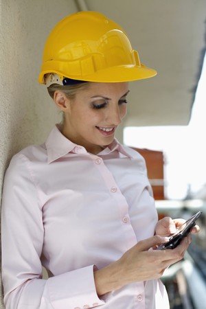 Female architect text messaging on the phoneの写真素材