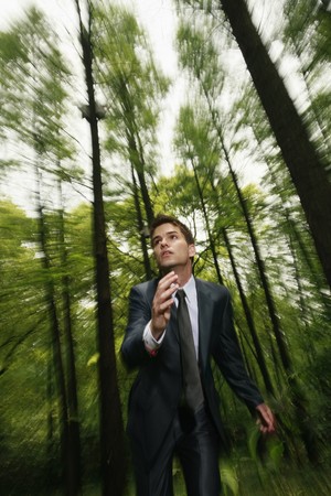 Businessman running in the forestの写真素材