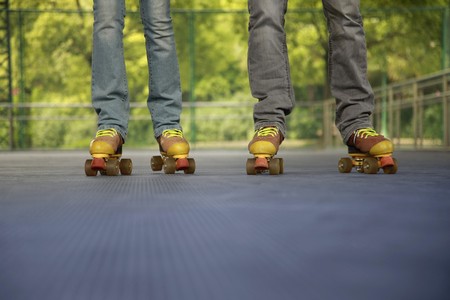 Man and woman roller skating togetherの写真素材