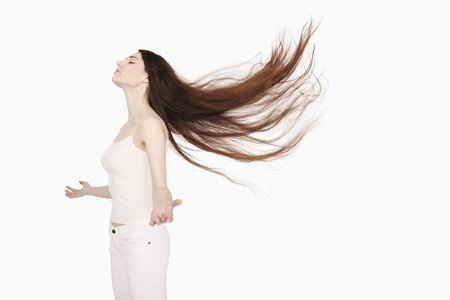 Woman with hair blowing in the windの写真素材