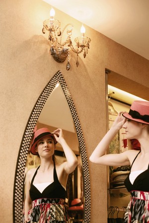 Woman trying on a hatの写真素材