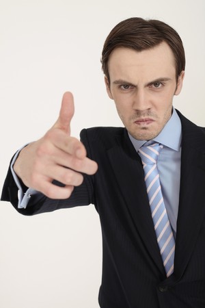 Businessman aiming with hands to shoot at cameraの写真素材