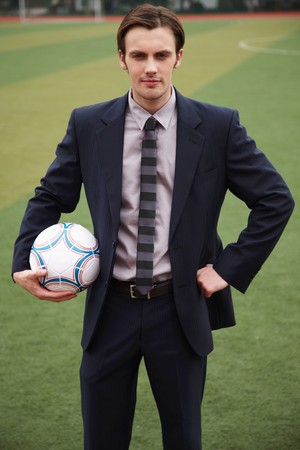 Businessman holding footballの写真素材