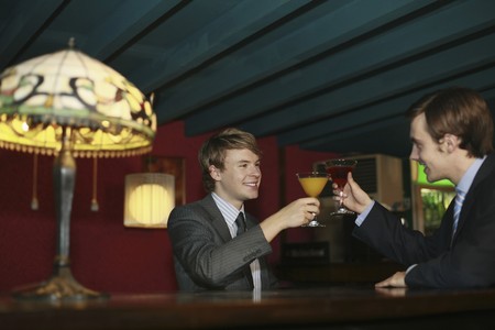 Businessmen toasting cocktailsの写真素材