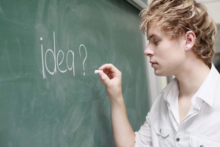 Man writing on blackboardの写真素材