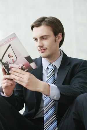 Businessman reading a bookの写真素材