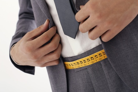 Man smiling with tape measure as his beltの写真素材