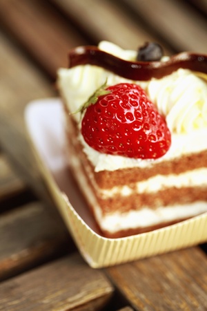 A chocolate sponge cake with strawberry and creamの写真素材