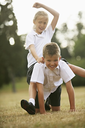 Boy and girl having fun in the parkの写真素材