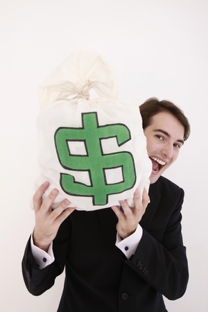 Businessman carrying money bag and smilingの写真素材