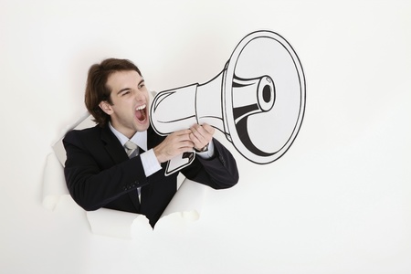 Businessman shouting through megaphoneの写真素材