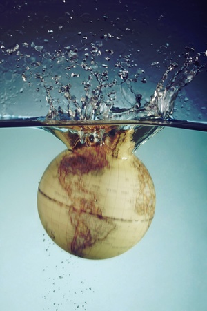 Globe hitting water surfaceの写真素材