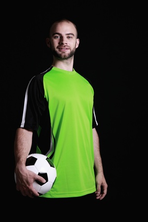 Man in football jersey holding a footballの写真素材
