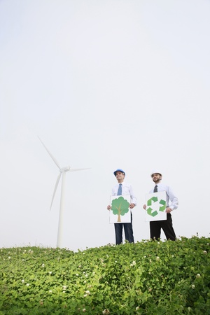Businessmen holding environmental friendly signの写真素材