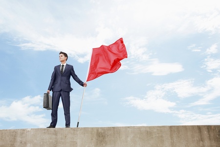 Businessman holding a red flagの写真素材