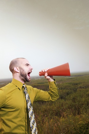 Businessman shouting through a megaphoneの写真素材
