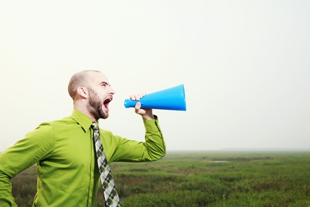 Businessman shouting through a megaphoneの写真素材