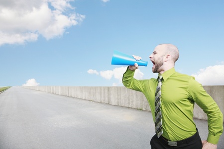 Businessman shouting through a megaphoneの写真素材