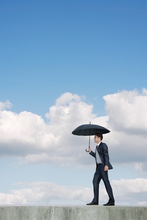 Businessman with an umbrellaの写真素材