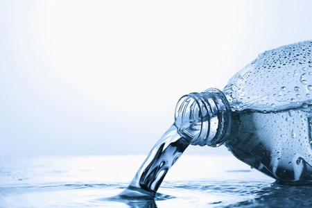 Water spilling from plastic bottleの写真素材