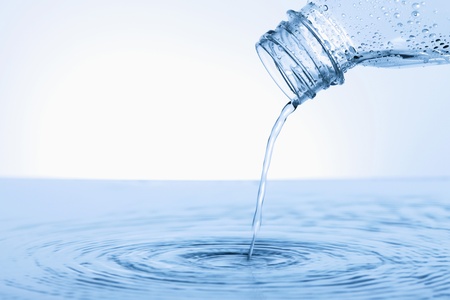 Water pouring from plastic bottleの写真素材