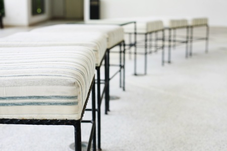 White cushioned foot stools in a rowの写真素材