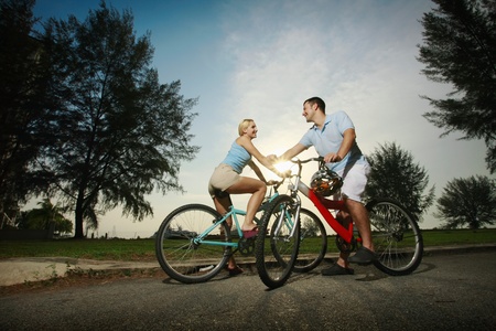 Man and woman cycling in the parkの写真素材