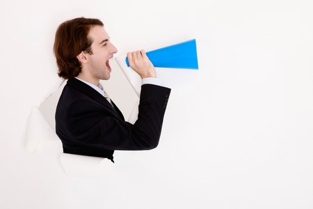 Businessman shouting through megaphoneの写真素材