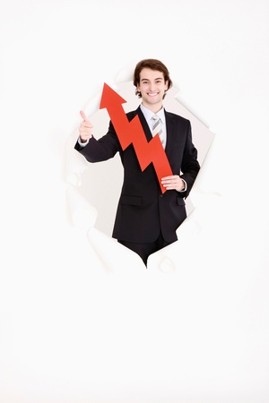 Businessman holding an arrow pointing upの写真素材