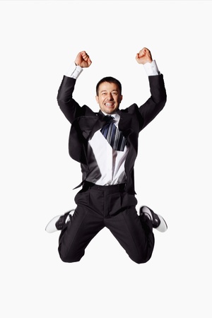 Businessman jumping up in joyの写真素材