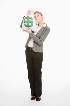 Businesswoman holding money bag close to her faceの写真素材