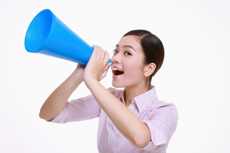 Businesswoman shouting through a megaphoneの写真素材