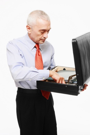 Businessman arranging files in his bagの写真素材