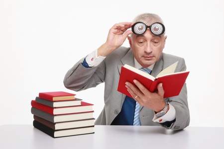 Businessman in funny glasses reading bookの写真素材
