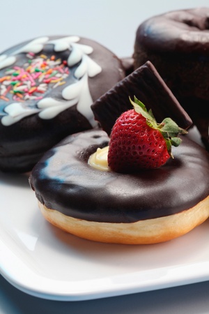 Donuts with icing on a plateの写真素材