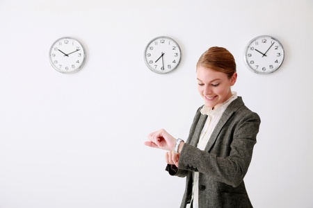 Businesswoman checking the time on her watch