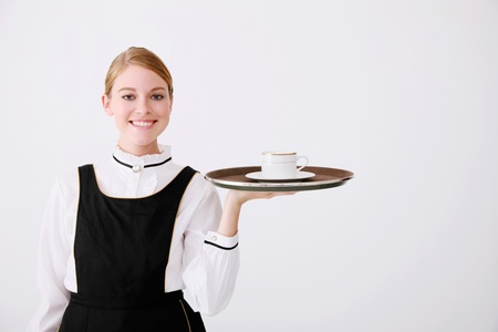 Waitress with a cup of coffee on trayの写真素材