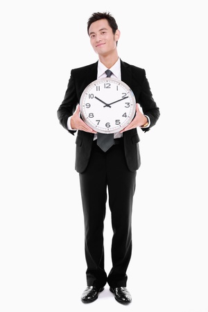 Businessman holding clockの写真素材