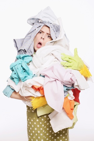 Woman with a pile of clothingの写真素材