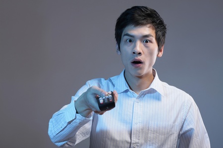 Man in shock while watching television