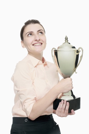 Businesswoman holding trophyの写真素材