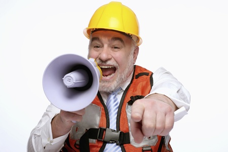 Man with hardhat pointing while shouting into megaphoneの写真素材