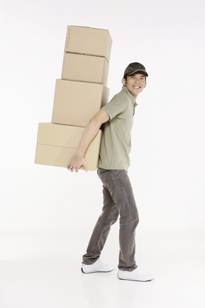 Man carrying a stack of packagesの写真素材