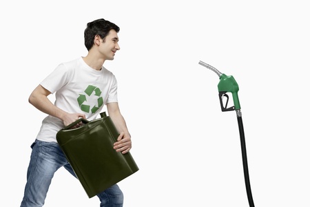 Man with gas can face to face with fuel pumpの写真素材
