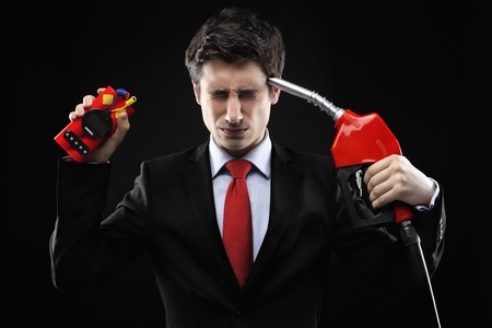 Businessman with time bomb and fuel pumpの写真素材