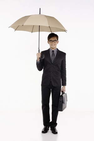 Businessman with umbrella and briefcaseの写真素材