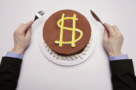 Businessman preparing to eat cake with dollar sign